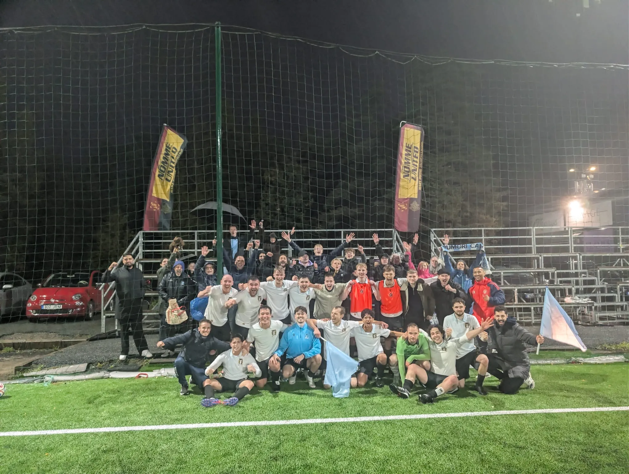Rumori players and supporters celebrate in front of the stand after an away win, September 2026